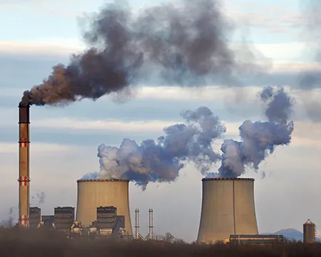 Power plant emitting smoke and steam pollution