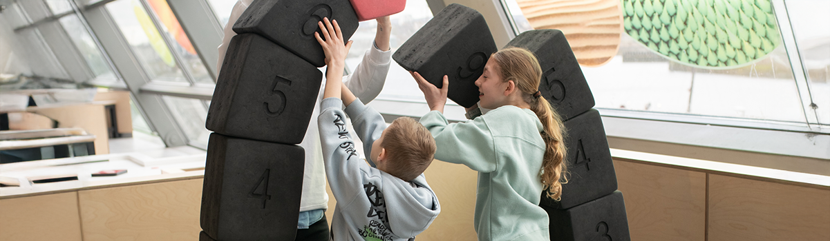 two children building a foam arch