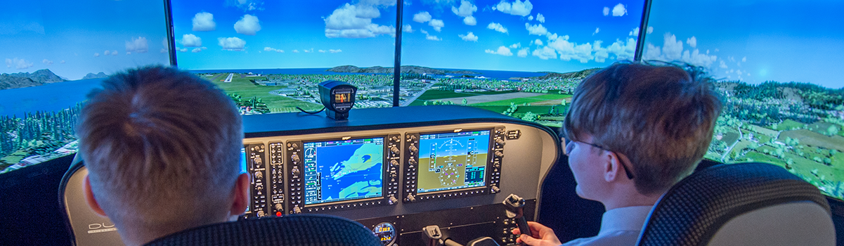 two children at the controls of the flight simulator