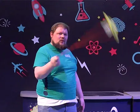 Presenter CJ spins a spinning tray in the science show theatre