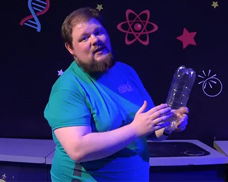 Presenter CJ holds a plastic bottle filled with hydrogen gas