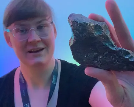 Presenter Nina holds a meteorite in her hand