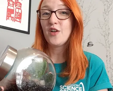 Presenter Jennifer holds a glass terrarium