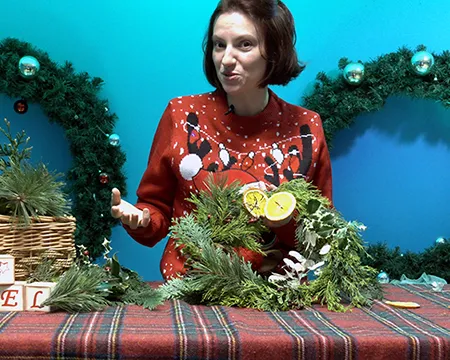 Sheena holds a Christmas wreath