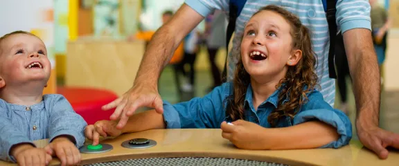 two children look up in excitement and amazement at one of the exhibits