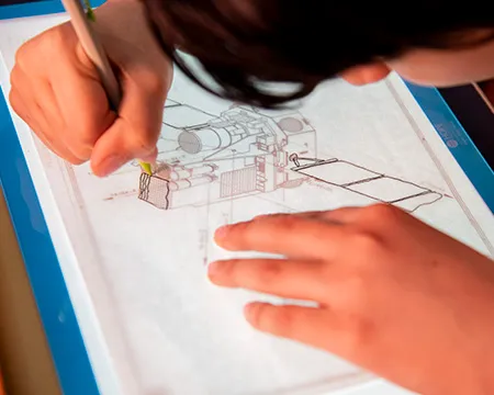 A pupil makes a technical drawing