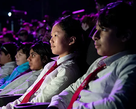 Pupils in the IMAX smile as they watch and listen to a presentation