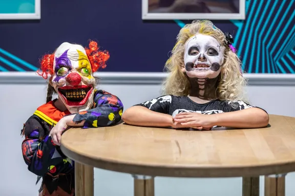 Two children in Halloween costumes at the Head on a Plate exhibit