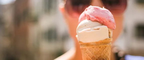 An ice cream being held up in front of a face