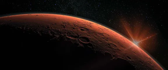 Mars - the red planet's horizon is illuminated in space