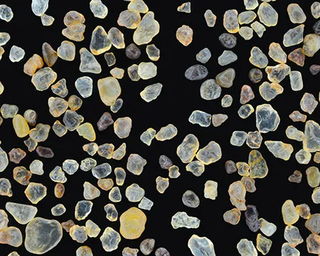 A close up of grains of sand against a black background