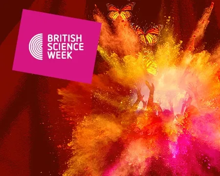 A colourful explosion of dust in yellows, oranges and reds with the raised hands on dancers behind it and butterflies in front. A British Science Week logo is stamped on the top left.