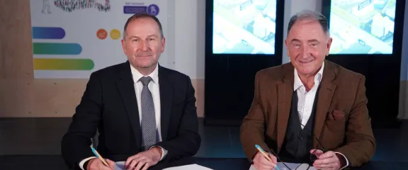 Dr Stephen Breslin and Sir Jim McDonald sign memorandum