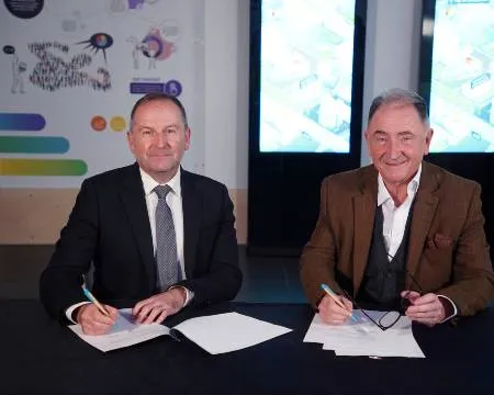 Dr Stephen Breslin and Sir Jim McDonald sign memorandum