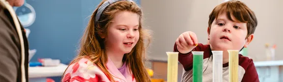 two children interact with a meet the expert's experiment