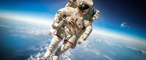 Astronaut in outer space against the backdrop of the planet earth. Elements of this image furnished by NASA.