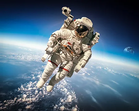 Astronaut in outer space against the backdrop of the planet earth. Elements of this image furnished by NASA.