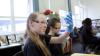 Pupils in a classroom conduct and experiment to collect carbon dioxide from a bottle in a balloon