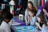 Visitors and experts playing a board game