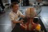 A pupil interacts with an hands-on exhibit about the human head